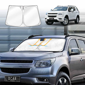 Car sunshade displayed on a silver car with a white Holden-Colorado7 SUV in the background.