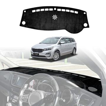Kia Carnival 2015–2020 black dashboard dash mat installed, custom-fit non-slip dash cover protecting interior from UV damage and reducing windshield glare.