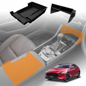 An image showing a black glove box armrest organizer tray, with a section depicting an orange armrest organizer tray, placed back into a Mazda 3 BP Series center console, with a red Mazda 3 BP Series car depicted in the background.
