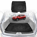 Car trunk with X-CAR black cargo liner and a red Nissan Dualis on a white background
