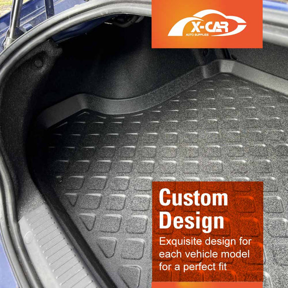 Car trunk with a custom-fit floor mat and X-Car logo in the corner.