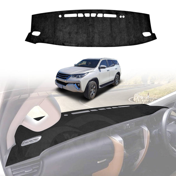 A black dash mat designed for a Toyota Fortuner, shown installed on the dashboard of a white Toyota Fortuner and separately on a table.