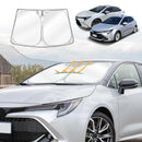 A graphic representation of a sun shade for a Toyota Corolla, showing the shade's placement on the vehicle and a foldable design.