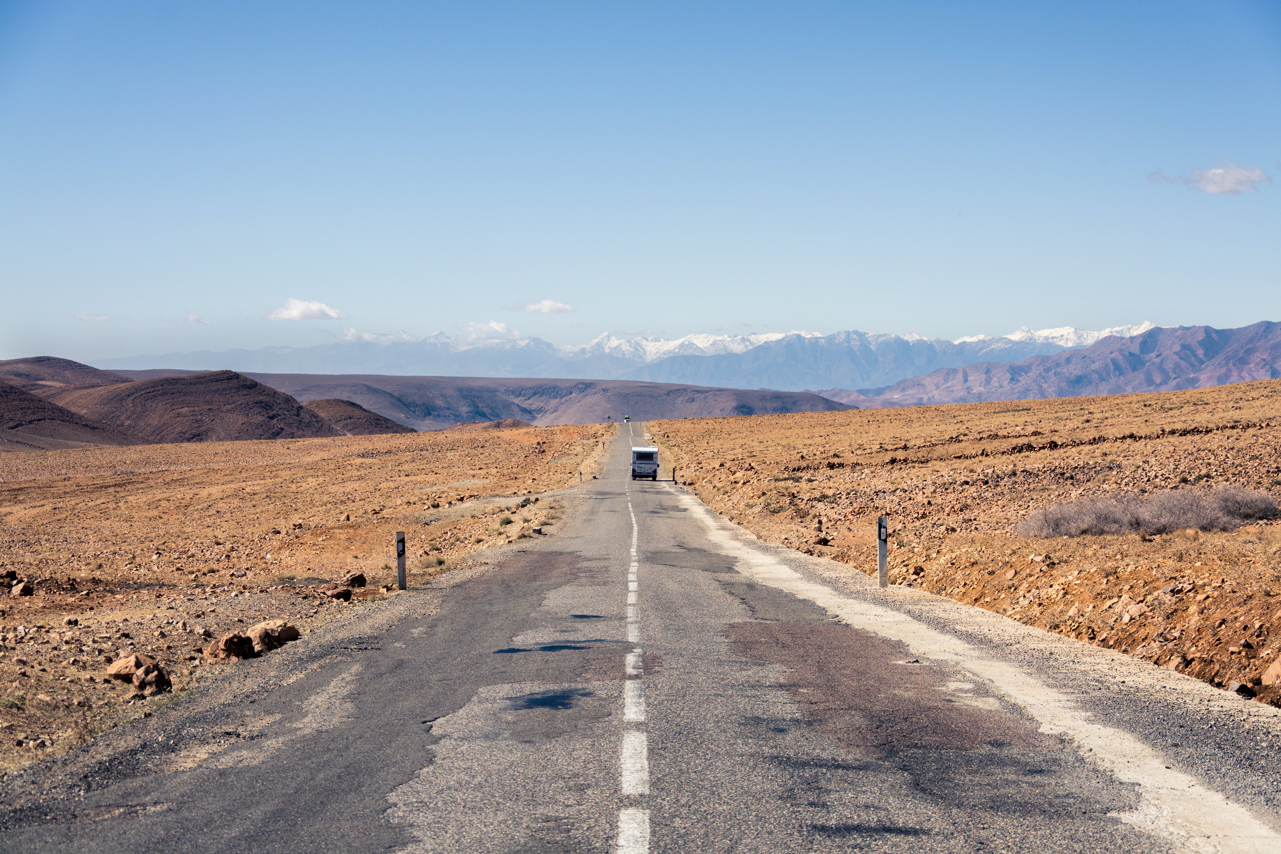View down the white line of an empty paved road