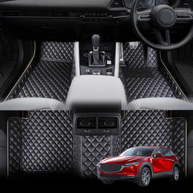 Black floor mats designed for a Mazda CX-30, displayed in the context of the vehicle's interior. The mats have a quilted design and the exterior of the vehicle is shown with a red color scheme.