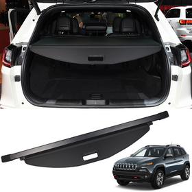 Retractable cargo cover installed on the interior of the trunk of a white Jeep Cherokee KL.